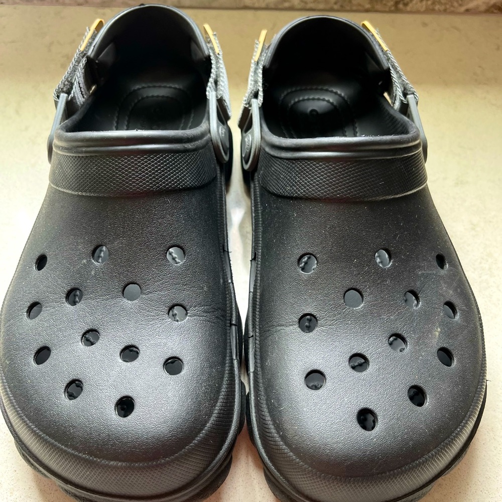 Black unisex Crocs with an outdoor/ bigger strap. Mens size 9, Women’s size 11.